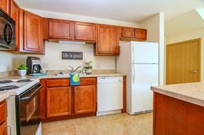 Madison apartment for rent - a kitchen with wooden cabinets and a white refrigerator
