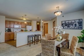 Cottage Grove apartment for rent - a dining room and kitchen with a table and chairs