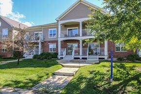 Cottage Grove apartment for rent - a large house with a yard and a tree in front of it