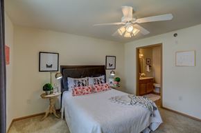 Cottage Grove apartment for rent - a bedroom with a large bed and a ceiling fan