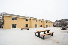 Madison townhouse for rent - a courtyard with picnic tables and buildings in the snow