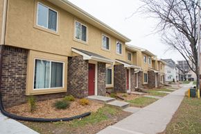 Madison townhouse for rent - a sidewalk in front of a row of apartments with red doors