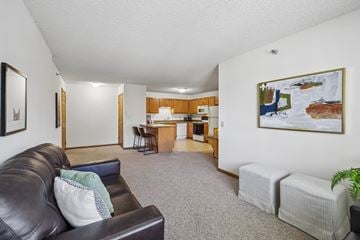 Madison apartment for rent - A living room with a couch, chair, and a painting on the wall.