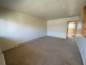 Seattle apartment for rent - an empty living room with white walls and carpet