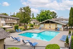 Fife apartment for rent - A pool surrounded by lawn chairs and trees.