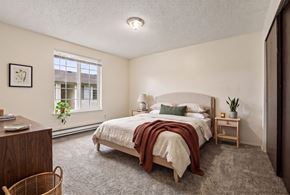 Fife apartment for rent - A bedroom with a bed, nightstand, and window.