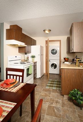 Fife apartment for rent - a kitchen with a table and a refrigerator and a washing machine