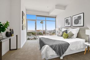 Culver City apartment for rent - A bedroom with a large bed and a view of the city.