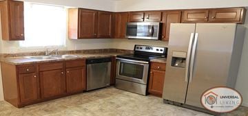 Johnson City apartment for rent - a kitchen with stainless steel appliances and wooden cabinets