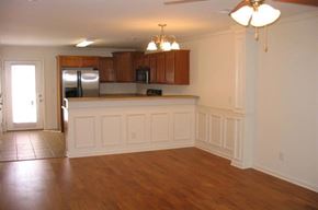 Johnson City apartment for rent - an empty living room and kitchen with a wood floor