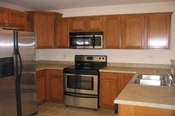 Johnson City apartment for rent - a kitchen with stainless steel appliances and wooden cabinets