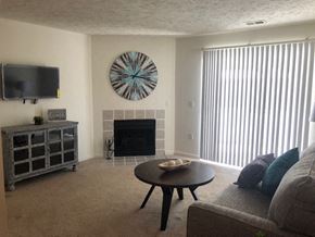 Omaha apartment for rent - a living room with a fireplace and a table