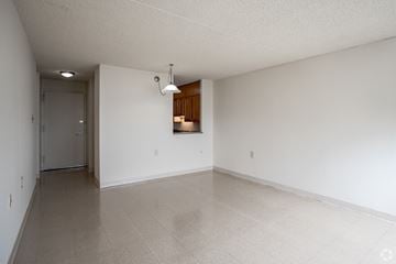 Atlantic City apartment for rent - the living room and dining room of an empty house with white walls and tile floors