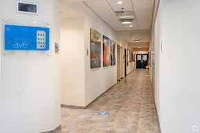 Atlantic City apartment for rent - a hallway with paintings on the walls and a blue sign on the wall