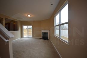 Charlotte house for rent - an empty living room with a fireplace and a large window