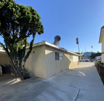 Harbor City triplex for rent - A house with a tree in front of it.