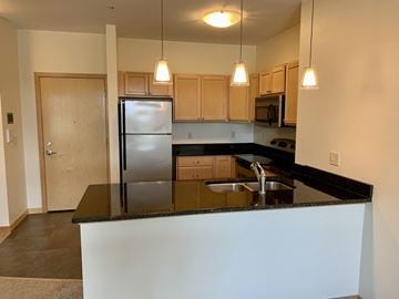 Eau Claire apartment for rent - a kitchen with a counter top and a refrigerator