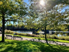 Eau Claire apartment for rent - a park bench overlooking a river and a bridge