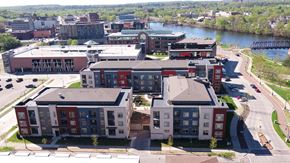 Eau Claire apartment for rent - an aerial view of a city with buildings and a river
