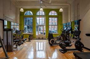 Philadelphia apartment for rent - a gym with treadmills and weights in a room with windows
