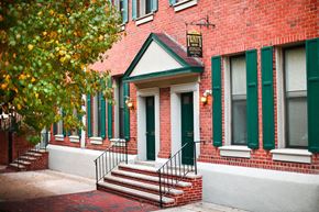 Philadelphia apartment for rent - a red brick building with green doors and stairs