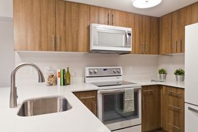 Philadelphia apartment for rent - a kitchen with white appliances and wooden cabinets