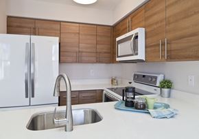 Philadelphia apartment for rent - a kitchen with white counter tops and wooden cabinets
