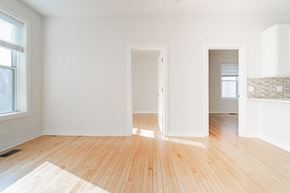 Chicago apartment for rent - an empty living room with white walls and wood floors
