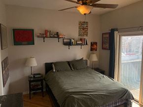 Chicago apartment for rent - a bedroom with a bed and a ceiling fan