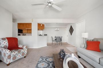 Groveport apartment for rent - A living room with a red chair and a grey couch.