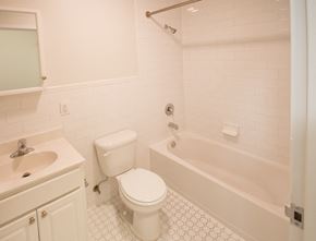 Newark apartment for rent - Bathroom with white cabinets and white tile floors
