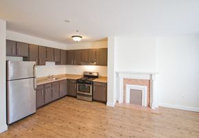 Newark apartment for rent - Kitchen with stainless steel appliances and living room with hardwood floors