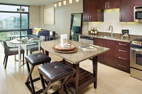 Washington apartment for rent - A modern kitchen with a dining table and chairs.