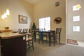 Big Rapids apartment for rent - a dining area with a table and chairs and a window