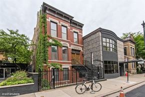Chicago apartment for rent - the facade of a building with a bike parked in front of it