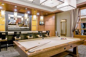 Baltimore apartment for rent - A pool table in a room with a mirror and a TV.