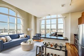 Baltimore apartment for rent - A modern kitchen with a large window overlooking the city.