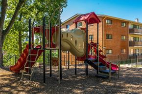 Bladensburg apartment for rent - a playground with a slide and climbing equipment in front of a building