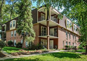 Crofton apartment for rent - a brick apartment building with a lawn and trees