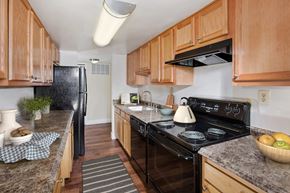 Crofton apartment for rent - a kitchen with black appliances and wooden cabinets