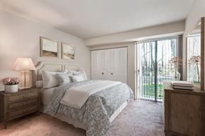 Hillcrest Heights apartment for rent - a bedroom with a bed and a door to a balcony