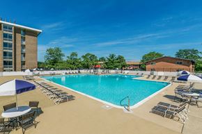 Hillcrest Heights apartment for rent - our resort style pool is surrounded by chairs and umbrellas