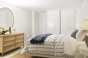 Baltimore apartment for rent - A bedroom with a bed, a dresser, and a wardrobe.