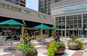 Baltimore apartment for rent - A patio area with tables and chairs and umbrellas.