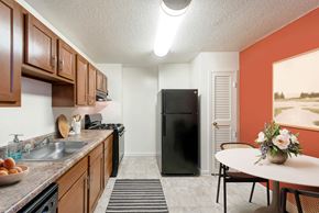 Silver Spring apartment for rent - our apartments offer a kitchen with a black refrigerator and a table