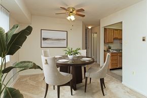 Lanham apartment for rent - a dining room with a table and chairs and a ceiling fan