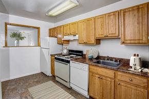 Cockeysville apartment for rent - a kitchen with white appliances and wooden cabinets