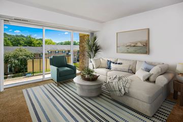 Cockeysville apartment for rent - a living room with a white couch and a blue and white striped rug