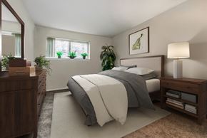 New Carrollton apartment for rent - a bedroom with a bed and a dresser and a window