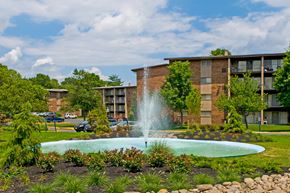New Carrollton apartment for rent - a fountain in a garden in front of an apartment building